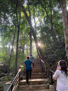 a group of people walking up some stairs at Gramasiri Homestay in Sringeri