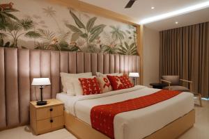 a bedroom with a large bed with red pillows at ORYN-Celebrity Resort, Shamirpet, Hyderabad, Secunderabad, in Shamirpet +27 photos