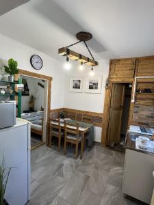 a kitchen and dining room with a table and a room at Amur Vendégház in Gárdony +27 photos