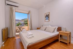 a bedroom with a bed and a large window at Villa Botanica near Split - Heated Pool and Garden in Kučine +39 photos