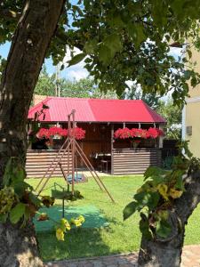 a playground in front of a building with a red roof at Casa Dany in Vatra Dornei