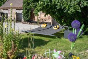 a hammock in the grass in a yard at Döbrögi Wellness Vendégház in Nemesvita