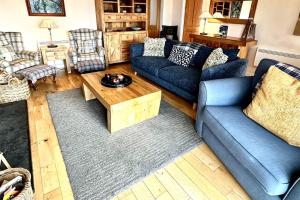 a living room with blue couches and a coffee table at Dunhallin Ard in Hallin +58 photos