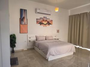 a bedroom with a bed in a white room at Moonlight Resort in Sinādil +31 photos