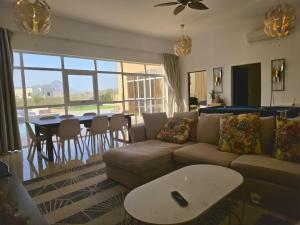 a living room with a couch and a table at Moonlight Resort in Sinādil
