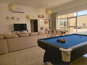 a living room with a pool table in it at Moonlight Resort in Sinādil
