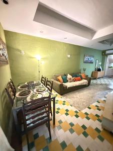 a living room with a couch and a table and chairs at Arantza House in Sliema