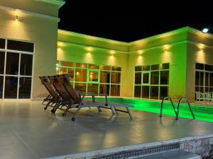 two chairs sitting in front of a building at night at Moonlight Resort in Sinādil