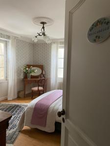 a bedroom with a bed and a table and window at Chateau Du Payre in Cardan