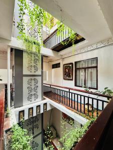 a building with a balcony with plants in it at BlueHome Apartment in Vientiane