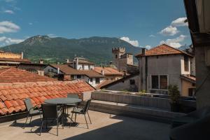 a patio with a table and chairs on a roof at Albergo Accademia in Trento