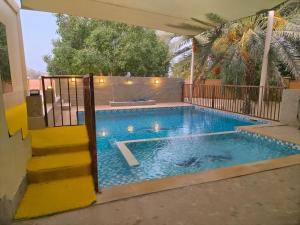 a swimming pool in a house with at Hatta Orchard in Hatta