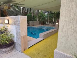 a swimming pool in a backyard with a patio at Hatta Orchard in Hatta