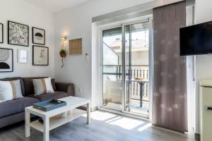 a living room with a couch and a table at Apartment Pink Vistalegre in Torrevieja