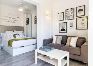 a living room with a bed and a couch at Apartment Pink Vistalegre in Torrevieja