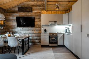 a kitchen with a table and a dining room at Chalet Ruka Aurelius in Ruka
