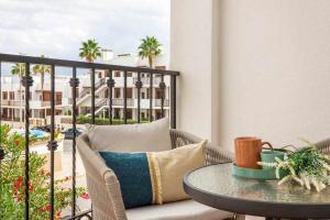 a balcony with a table and a view of a building at Bungalow Pink Punta Prima in Alicante