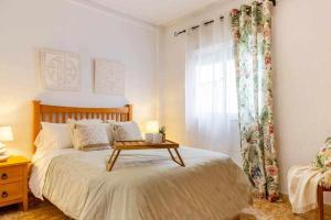 a bedroom with a bed with a table on it at Bungalow Pink Punta Prima in Alicante +39 photos