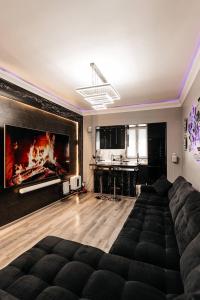 a living room with a couch and a large fireplace at Modern Canadian Style Unit in Tashkent