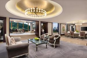 a living room with a large gold ceiling at Grand Pacific Hotel Ningbo in Yuyao