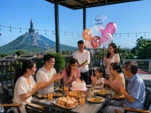 a group of people sitting around a table with a cake at Tam duc villa in Tây Ninh +23 photos