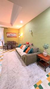a living room with a couch and a table at Arantza House in Sliema