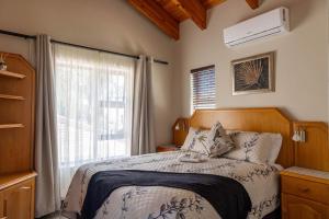 a bedroom with a bed and a large window at Bon A Vie Self-catering and b&b Gonubie Full Solar Power, no load shedding! in Gonubie +90 photos
