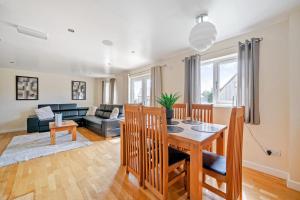 a living room with a table and a couch at Charcoal Lodge in Brigg