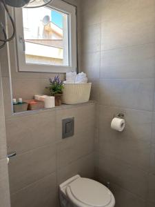 a small bathroom with a toilet and a window at White Rose 2 in Bar +32 photos
