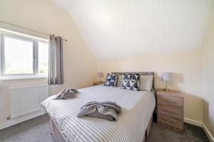 a bedroom with a bed and a window at Charcoal Lodge in Brigg