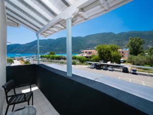 a balcony with a view of the ocean and mountains at Salty Dog Suites in Vasiliki