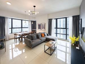 a living room with a couch and a table at Arte Plus Jalan Ampang by Airhost in Kuala Lumpur
