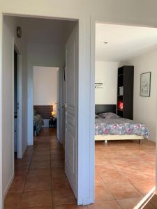 a bedroom with a bed and a hallway at Hacienda in Caumont