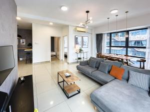 a living room with a couch and a table at Arte Plus Jalan Ampang by Airhost in Kuala Lumpur
