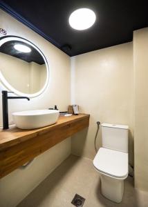 a bathroom with a sink and a mirror at Salty Dog Suites in Vasiliki