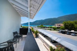 a balcony with chairs and a view of the ocean at Salty Dog Suites in Vasiliki