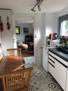 a kitchen with a table and a counter top at Bienvenue à Evian in Neuvecelle