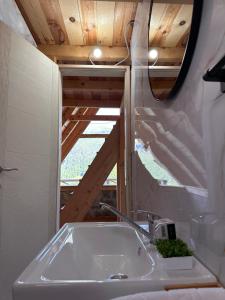 a bathroom with a sink in front of a window at Retreat Komovi in Andrijevica
