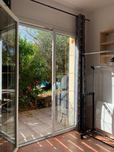 an open sliding glass door on a patio at Hacienda in Caumont