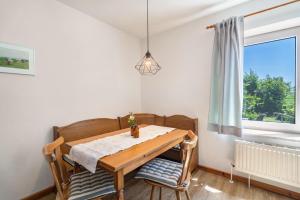 a dining room table with two chairs and a window at Fewo Hanna Tedsen in Pellworm