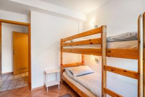 a bedroom with two bunk beds and a hallway at Fewo Hanna Tedsen in Pellworm