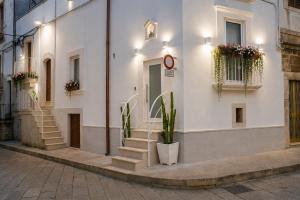a white building with stairs on the side of it at Dimora Camponobile - Turi in Turi