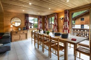 a kitchen with a large wooden table and chairs at Chalet Snow Mountain in Le Bettaix