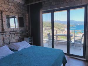 a bedroom with a bed and a view of the ocean at Villa Lydia in Meganisi