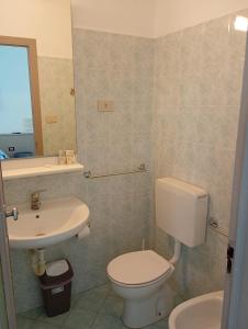 a bathroom with a toilet and a sink at Hotel Europa in Arma di Taggia