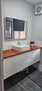 a bathroom with a sink and a mirror at Drummond Cove Holiday Park in Drummond Cove +52 photos