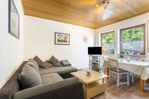 a living room with a couch and a table at Ferienwohnung Lisa in Medebach +19 photos