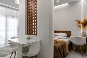 a bedroom with a bed and a table and chairs at Elite Suite in Xanthi