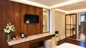 a hotel room with a television on a wall at Alaturka Mansion in Istanbul +17 photos