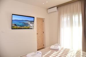 a bedroom with a bed with a picture on the wall at Villa Kostas Sarti in Sarti